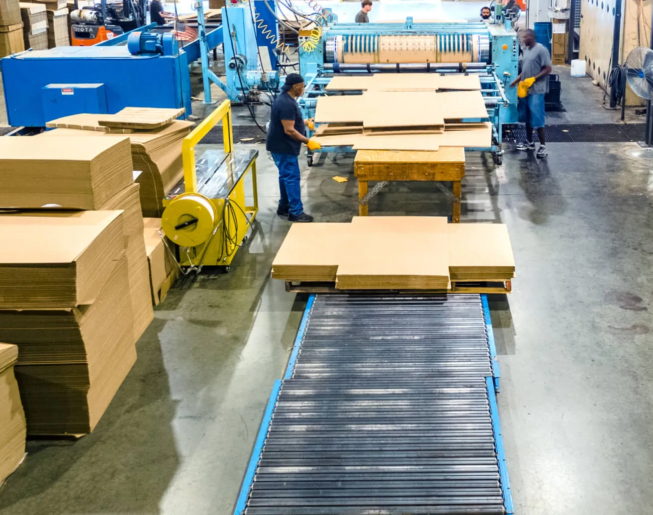 Rotary die cutter with operators stacking finished blanks